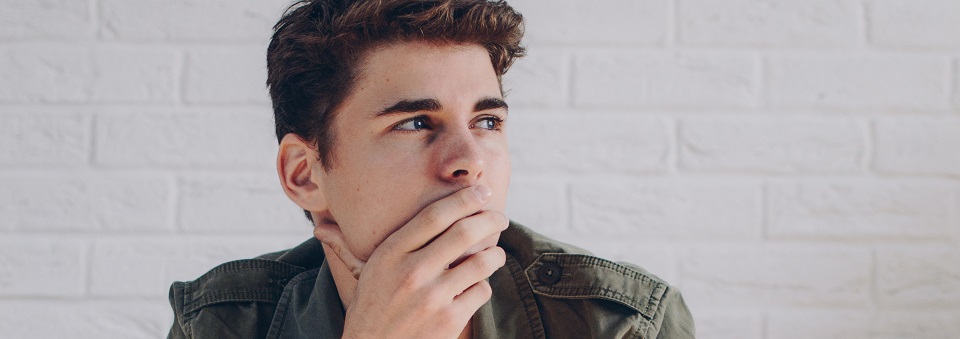 man wearing a jacket sitting on brown wooden crate 594610